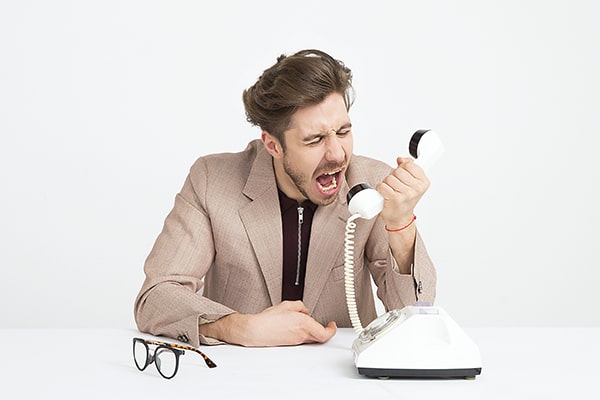 Homem gritando de raiva ao telefone