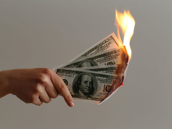 Quatro notas de 100 dólares pegando fogo